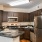 Spacious and well lit kitchen with wood flooring and stainless steel appliances