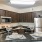 Spacious and well lit kitchen with wood flooring and stainless steel appliances